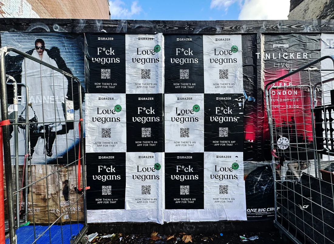 F*ck vegans and Love vegans posters on a street hoarding
