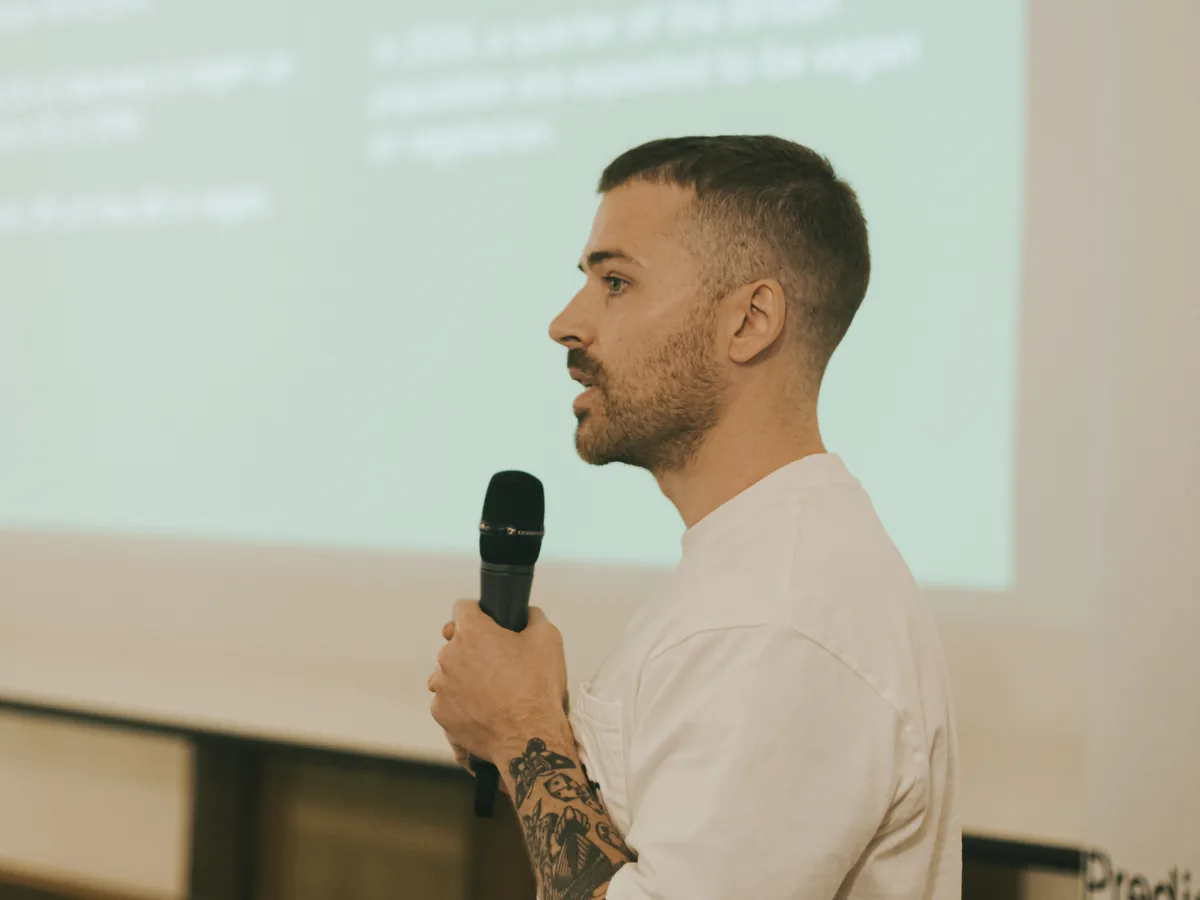 Lewis Foster pitching on stage with a microphone
